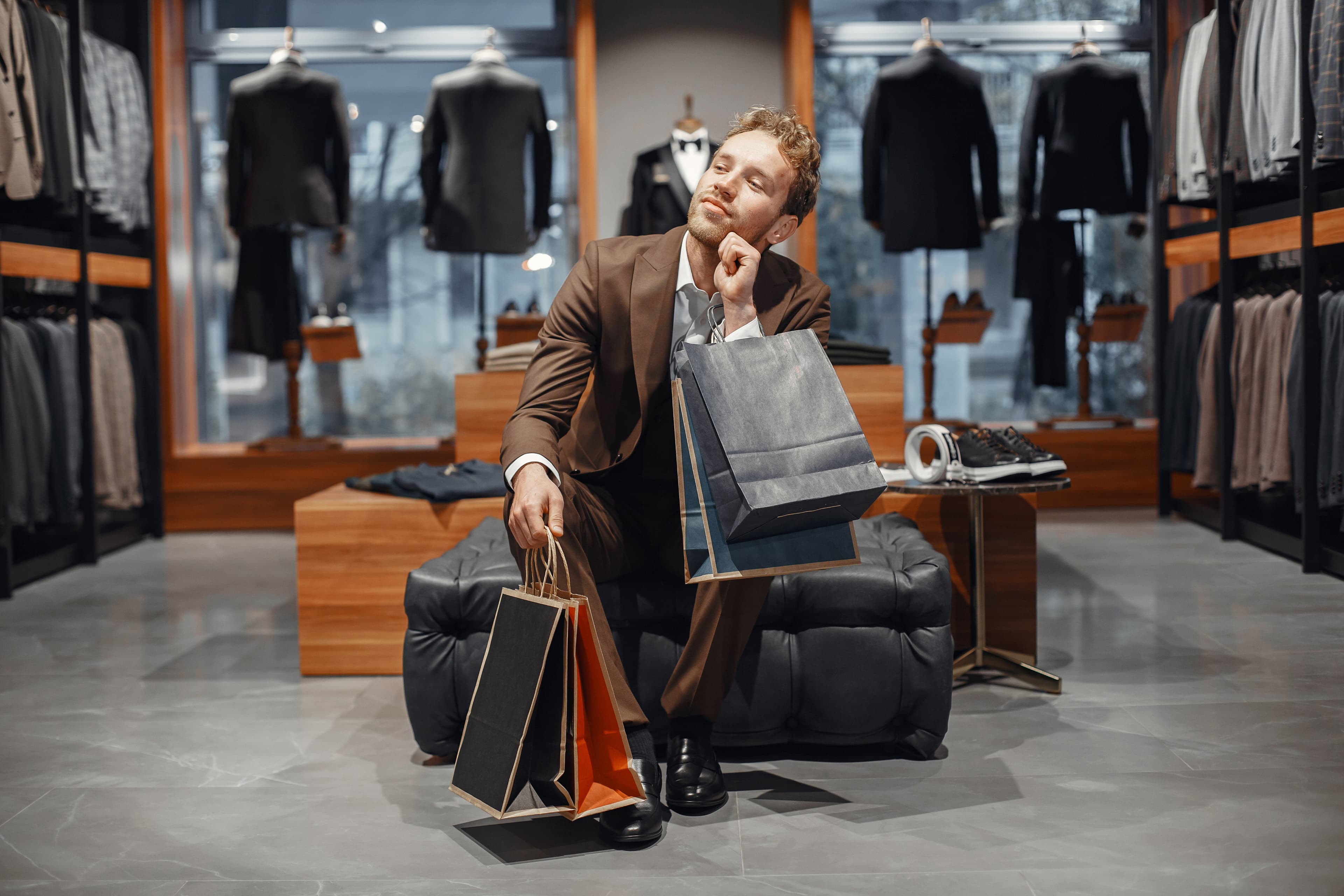A woman showcasing formal suits at a clothing store